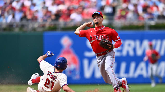 Aug 30, 2023; Philadelphia, Pennsylvania, USA; Los Angeles Angels shortstop Andrew Velazquez (4) turns a double play over Philadelphia Phillies catcher Garrett Stubbs (21) in the fourth inning at Citizens Bank Park.